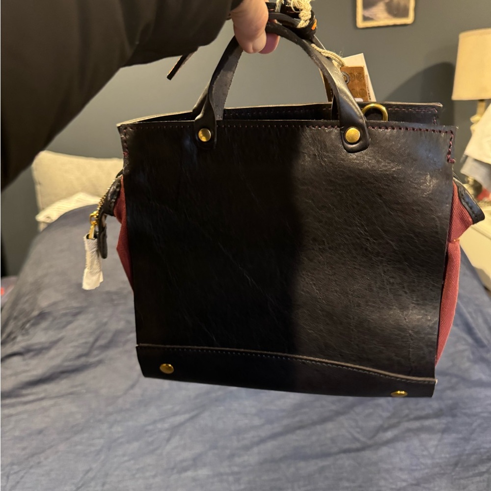 New .. brown leather, maroonish inside. Small, night out on the town purse